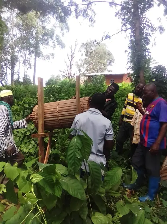 people setting up the bee hive